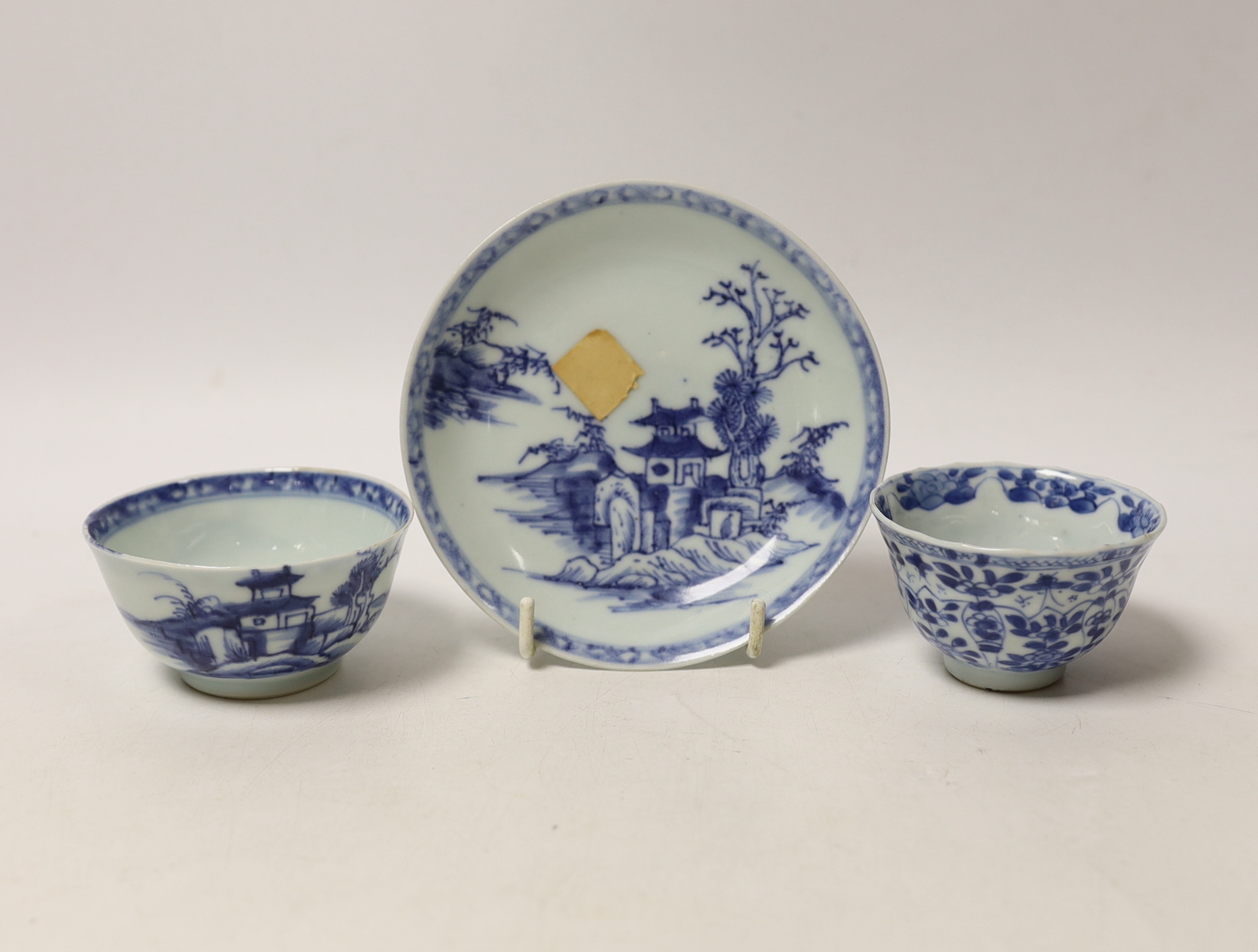 A Chinese Nanking Cargo blue and white saucer and tea bowl, and a Kangxi blue and white tea bowl, largest 11.5cm in diameter